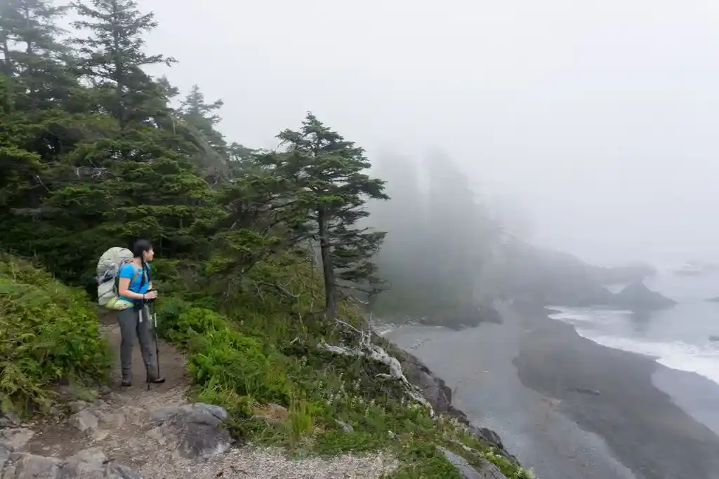A hiker on a foggy bluff near Nitinaht Narrows on the West Coast Trail