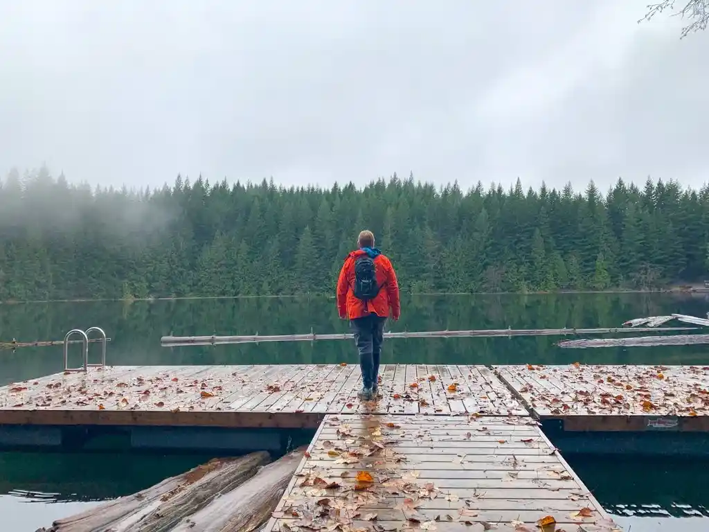 A man standing on the dock at the Cat Lake campground. One of the best places for camping in Whistler.