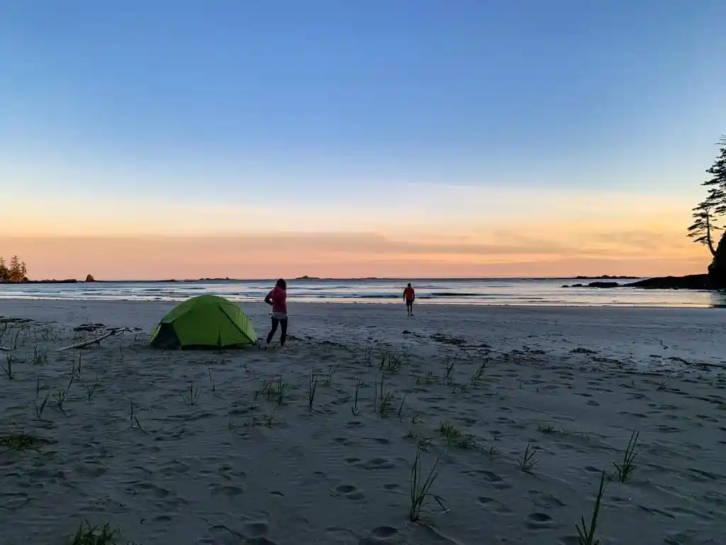 A tent on a sandy beach at sunset on the Tatchu Trail
