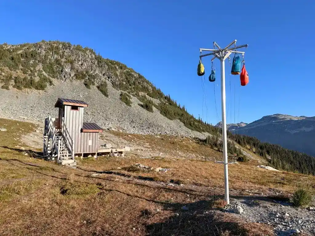 Toilet and food hanging poles at the Russet Lake Campground near Whistler