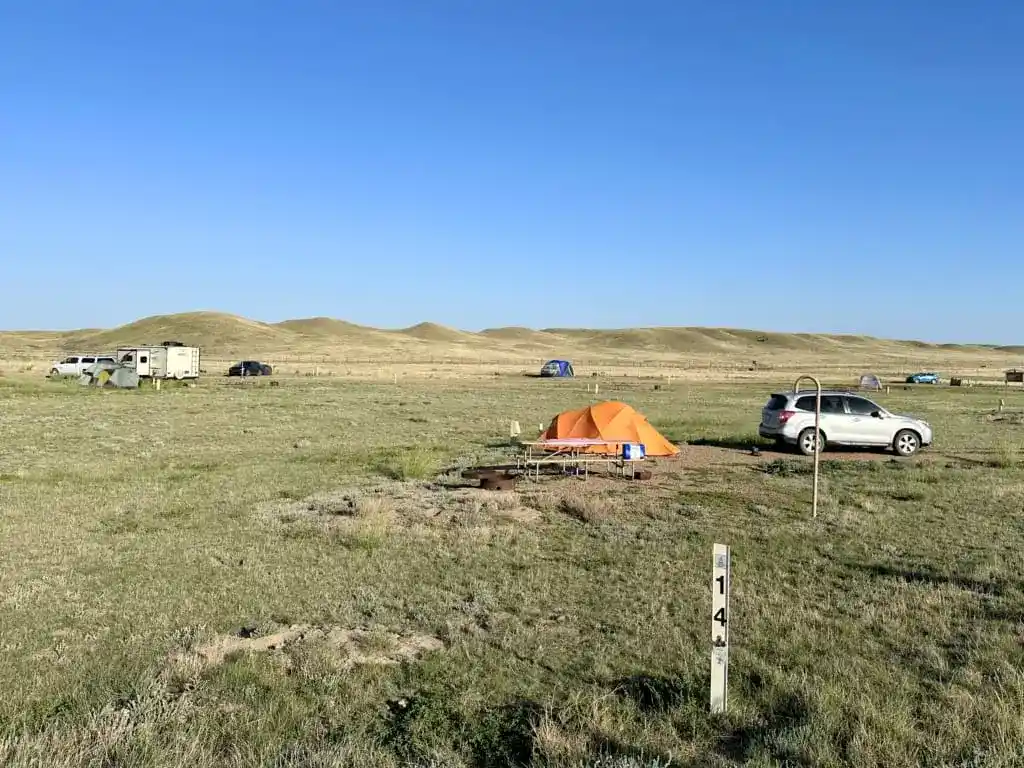 An orange tent next to a SUV at the Frenchman Valley Campground in Saskatchewan